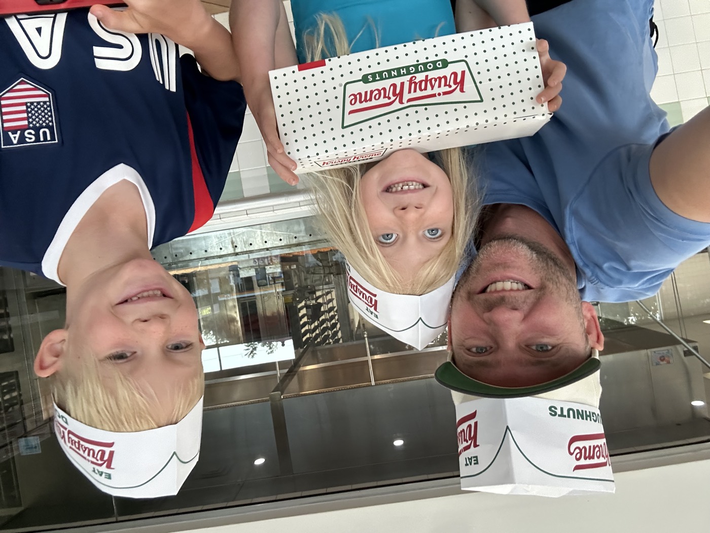 Alex with Miles and Caroline, celebrating with a box of doughnuts